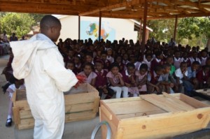 Kondwani demonstrating the importance of a bee suit.